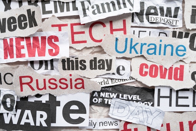 A collage of newspaper headlines and website screenshots from various news outlets (CNN, Fox News, MSNBC, Breitbart, The New York Times, etc.). Each headline is reporting on the same economic data point (e.g., unemployment rate), but the headlines are worded in ways that spin the data either positively or negatively, reflecting the outlet's political bias.