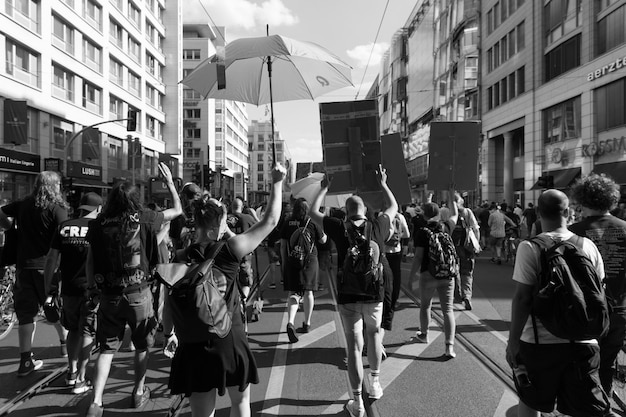 A black and white photograph from the Civil Rights Movement, showing protestors marching peacefully with signs. The determination on their faces and the unity of the crowd symbolize the power of shared stories and collective action in driving social change.