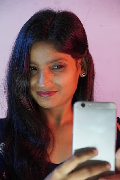 A close-up of a person's face illuminated by the glow of a smartphone displaying political advertisements. The person's expression is a mixture of curiosity and concern. The reflections in their eyes show snippets of different ads flashing rapidly, hinting at the overabundance of targeted information.