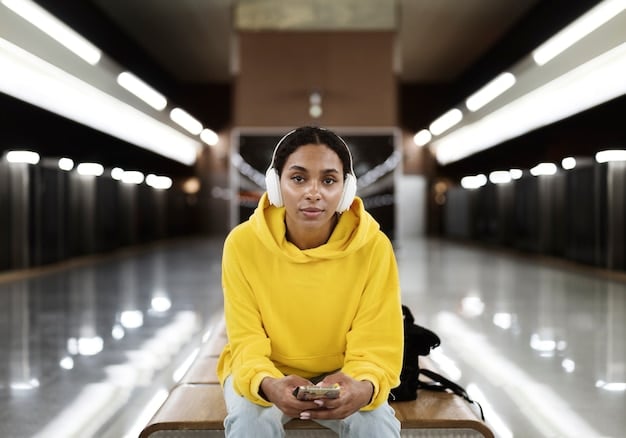A young African-American student sitting alone in a school hallway, looking dejected, with a blurred background showing other students interacting positively, highlighting the isolation and disproportionate impact of disciplinary actions on minority students.