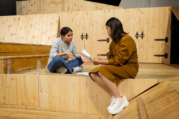 A school counselor kneeling to talk to a young student in a quiet corner of the library, symbolizing trauma-informed care and the importance of supportive relationships in addressing behavioral issues stemming from trauma.