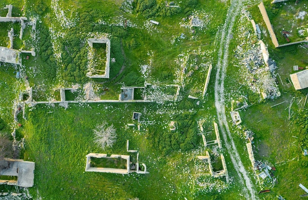 An aerial photo showing a stark contrast between a lush, green, affluent neighborhood and a polluted, industrial area with visibly poorer housing conditions adjacent to it.