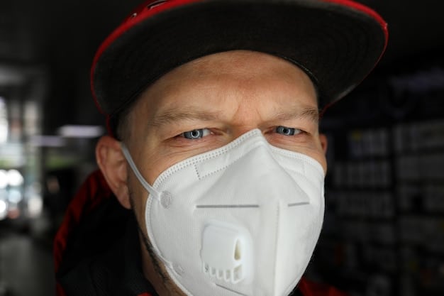 A close-up of a worker properly wearing a respirator mask in a dusty industrial environment, adhering to PPE regulations.