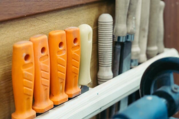 A close-up shot of various tools organized neatly on shelves in a tool library. Tools include saws, drills, and gardening equipment. A hand is reaching out to select a tool from the shelf.
