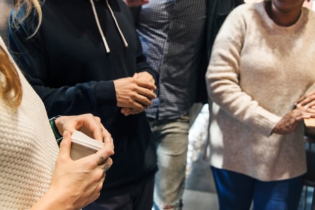 A photo of a networking event, with people exchanging business cards and engaging in conversation, representing the importance of building relationships with potential corporate sponsors.