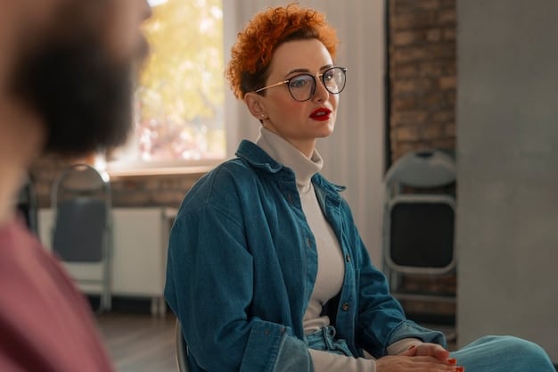 A close-up shot of a therapist sitting across from a young adult in a brightly lit, modern office. The therapist is listening attentively while the young adult speaks, conveying a sense of trust and empathy.