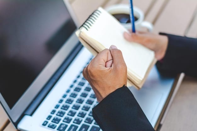 A close-up shot of hands holding a grant proposal document with a pen, surrounded by notes and a laptop displaying grant application forms, emphasizing meticulous preparation.
