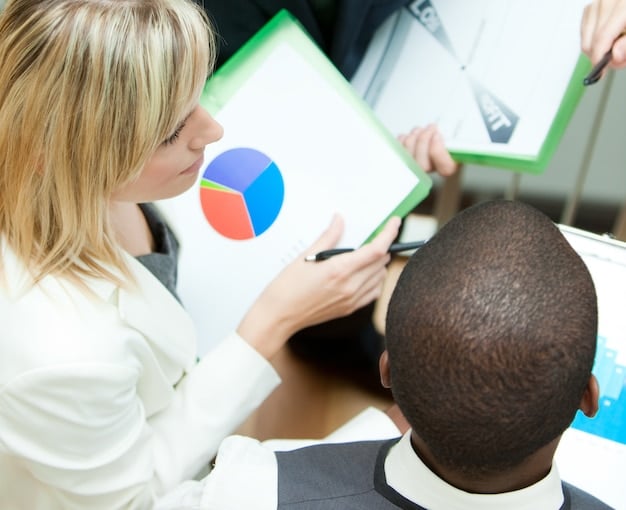 A close-up shot of a community member reviewing data charts and reports related to a needs assessment. The image emphasizes the importance of data analysis and interpretation in guiding action projects for Community Needs Assessment: Identifying the Most Pressing Issues and Designing Effective Action Projects.