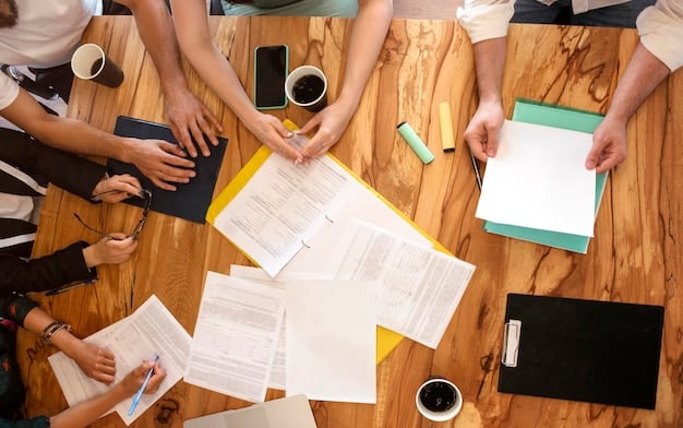 An overhead shot of a diverse group of hands signing legal documents on a wooden table. The documents have headings related to community projects, grants, and compliance. A pen is visible, emphasizing the formal aspect of the signatories.