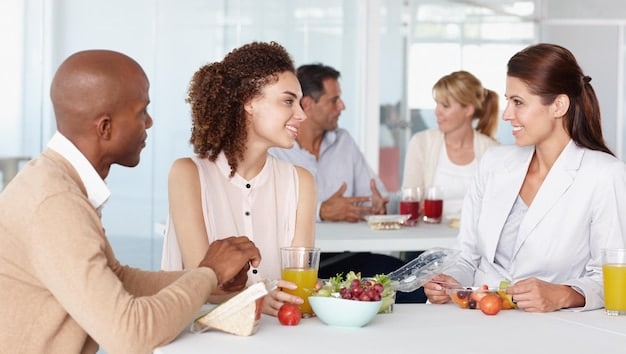 A public health professional conducting a nutrition workshop for a group of adults. The image depicts the professional explaining healthy food choices and demonstrating how to prepare nutritious meals. The setting is a community center kitchen, emphasizing hands-on learning and practical application of dietary advice for chronic disease prevention.