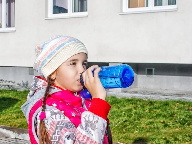 A child drinking water from a bottle in Flint, Michigan. The background shows dilapidated houses and a general sense of neglect. This image highlights the Examining the Impact of Climate Change on Social Justice: How are Vulnerable Communities Disproportionately Affected?, particularly in the context of environmental racism.