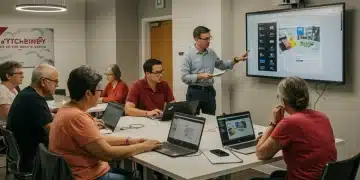 Adults learning digital skills in a modern workshop setting with laptops and an instructor.