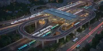 Modern public transportation hub with trains, buses, and light rail in a city at dusk, symbolizing future improvements.
